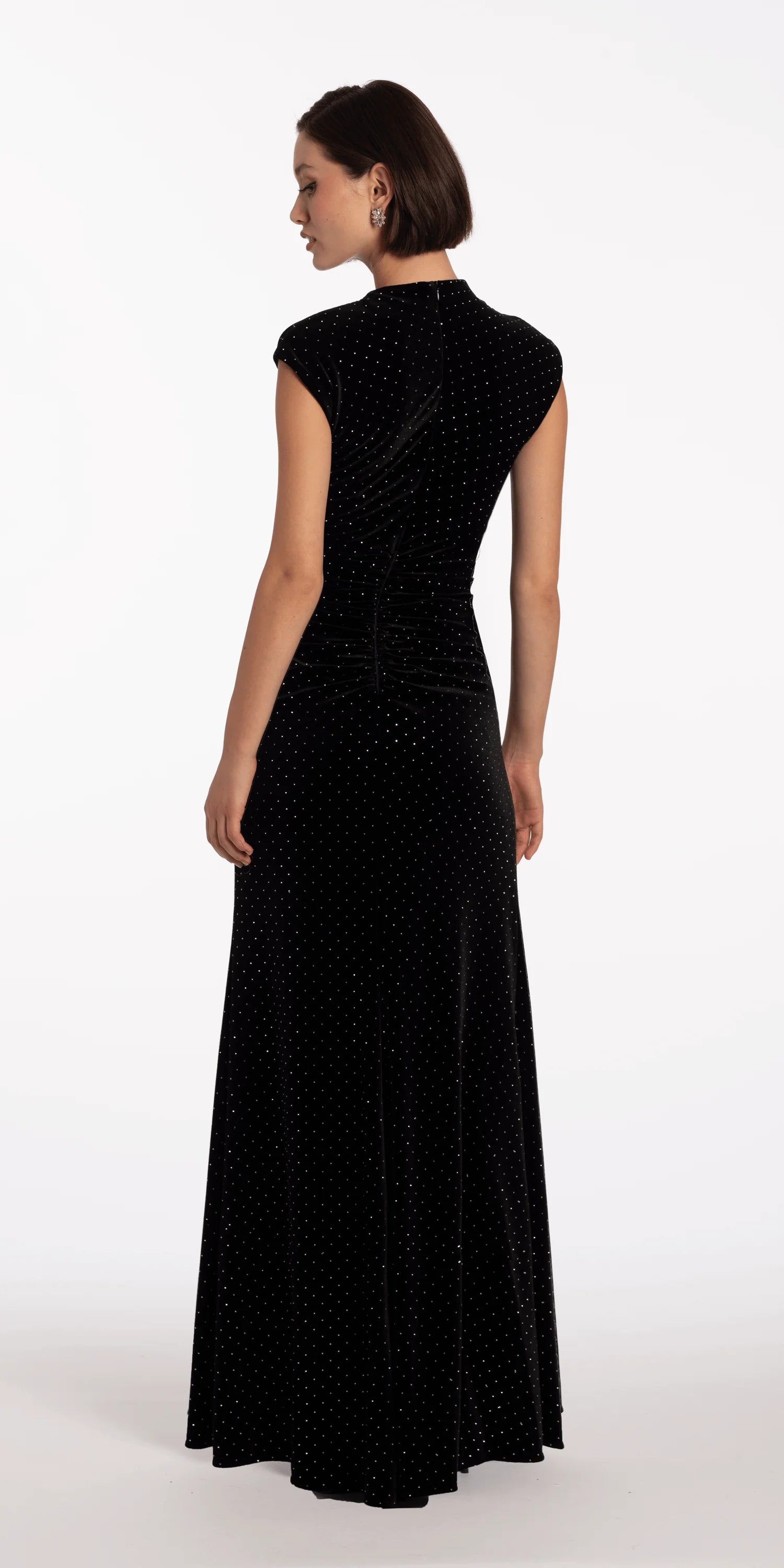 Elegant black velvet evening dress with cap sleeves, mock neck, ruched waist, and floor-length skirt with slit