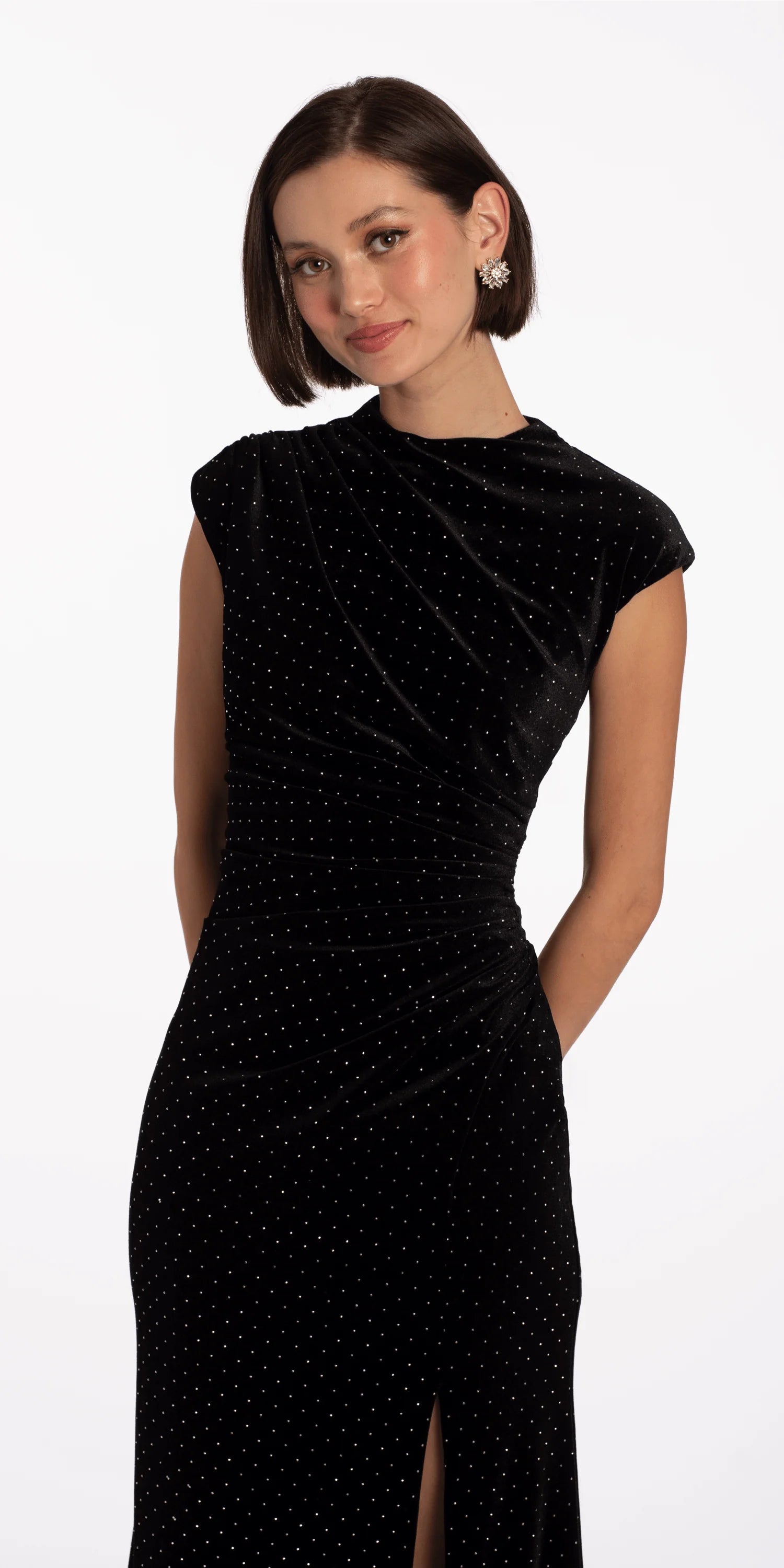 Elegant black velvet evening dress with cap sleeves, mock neck, ruched waist, and floor-length skirt with slit