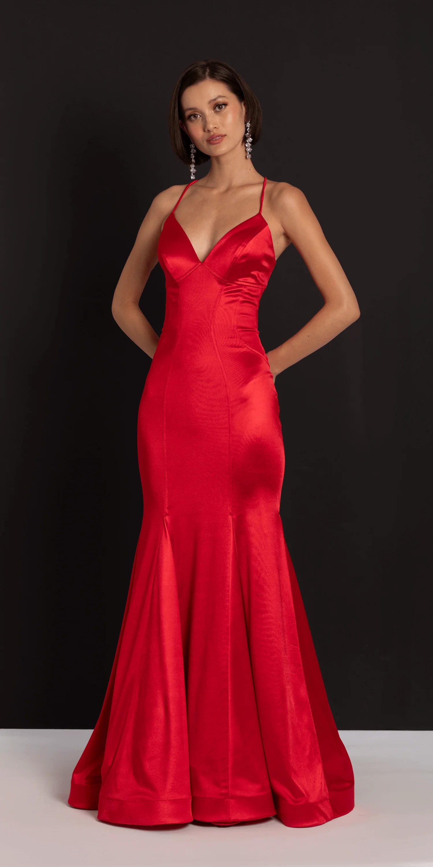 Glamorous red satin evening dress with spaghetti straps, deep V-neck, lace-up back, and mermaid skirt with train