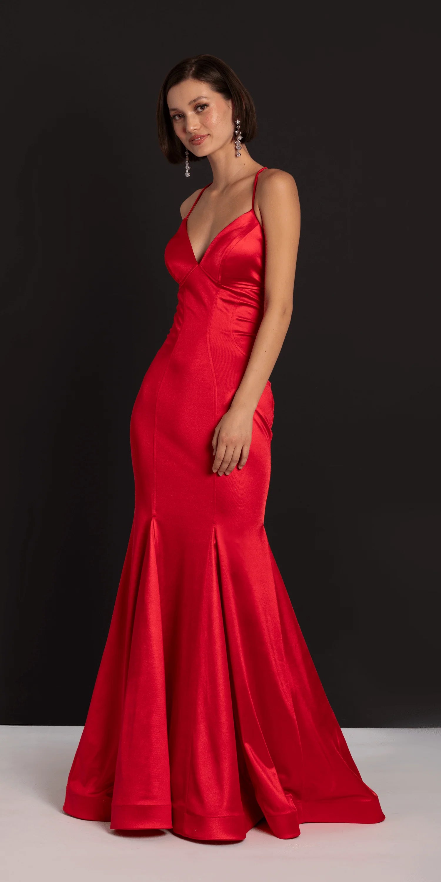 Glamorous red satin evening dress with spaghetti straps, deep V-neck, lace-up back, and mermaid skirt with train