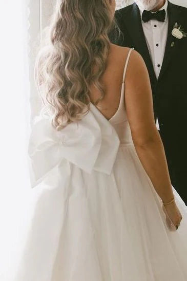 Spaghetti Strap Tulle Wedding Dresses with Deep V-Neck, Oversized Back Bow and Ruffled Tiered Skirt Bridal Gown
