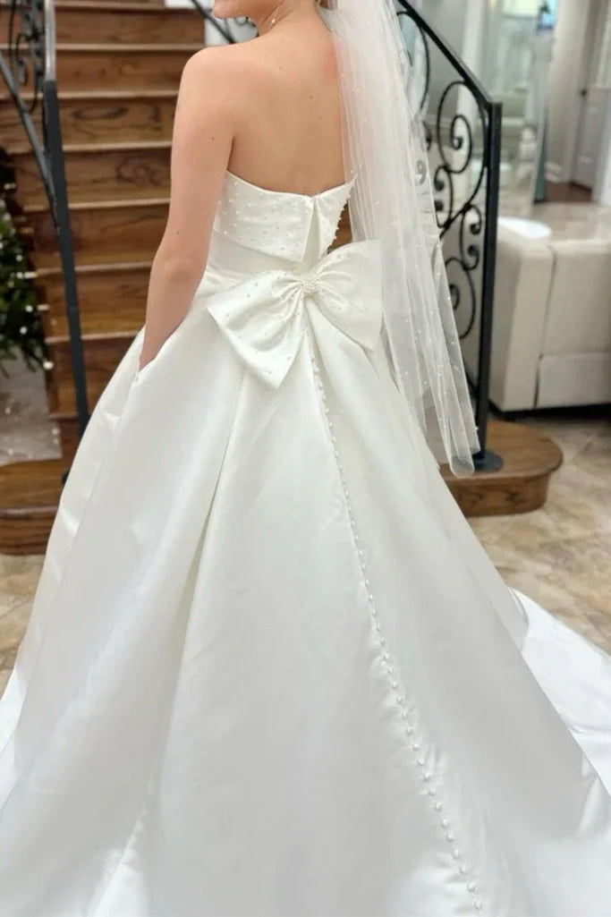 Strapless Satin Wedding Dresses with Pearl Embellishments, Oversized Back Bow, Side Pockets and Voluminous A-Line Skirt Bridal Gown